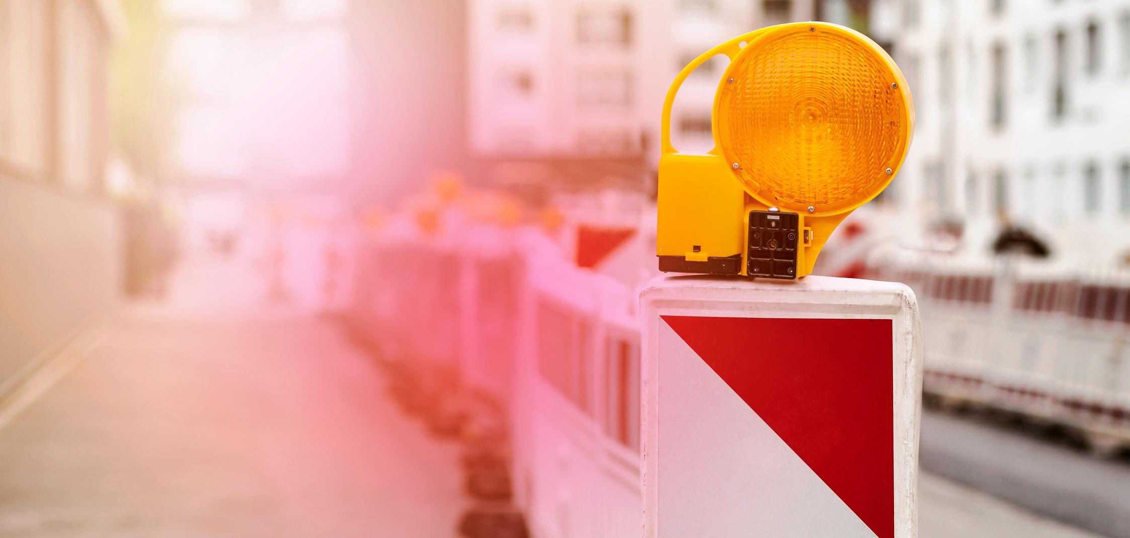 Mehrere Warnbarken stehen vor einer Baustelle